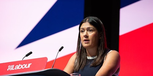 Lisa Nandy stadning before a Union Jack at a Labour event