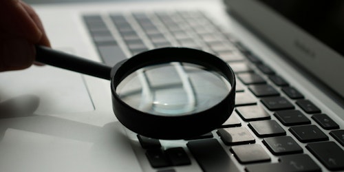 A magnifying glass on a laptop