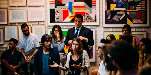 A woman talking in front of a focus group 