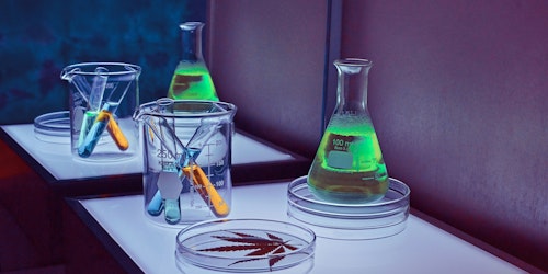 A set of science equipment lit up with green, blue and purple lights