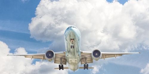 The underside of an airplane in flight, from a low angle