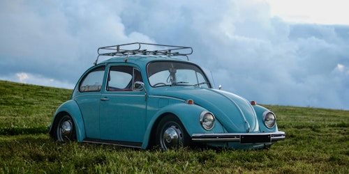 An old blue car in a field