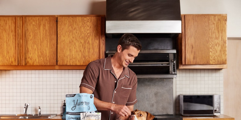 Antoni Porowski feeding his dog