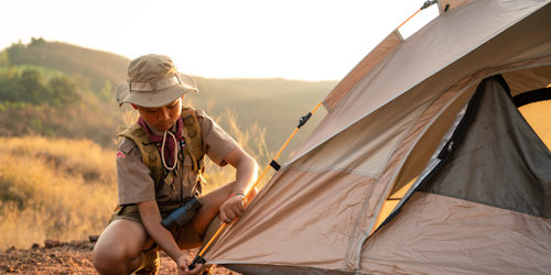 boy scout pitching a tent