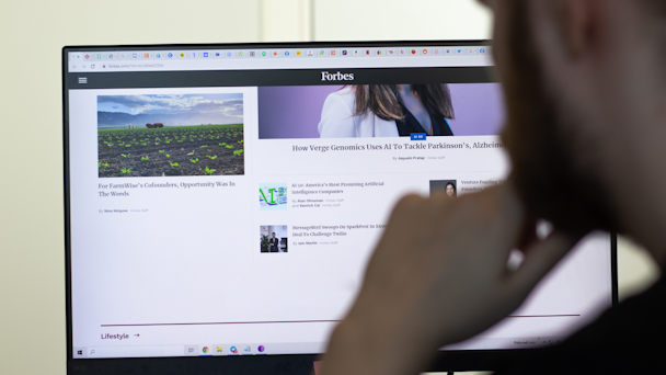 Man looking at Forbes.com