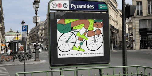 Illustration of a cyclist, created on an iPad, on an ad hoarding at the entrance of a Paris Metro station