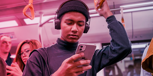 Man holding a rail on the subway - pink purple hue