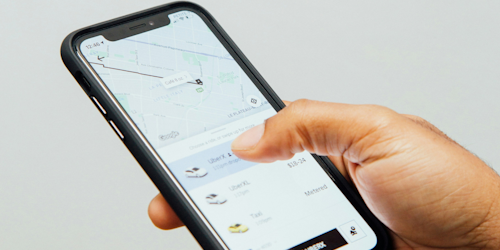 Uber app open on man's mobile phone