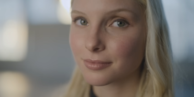 A still from Dove and Ogilvy's 'Cost of Beauty' campaign showing a closeup image of a blonde woman's face